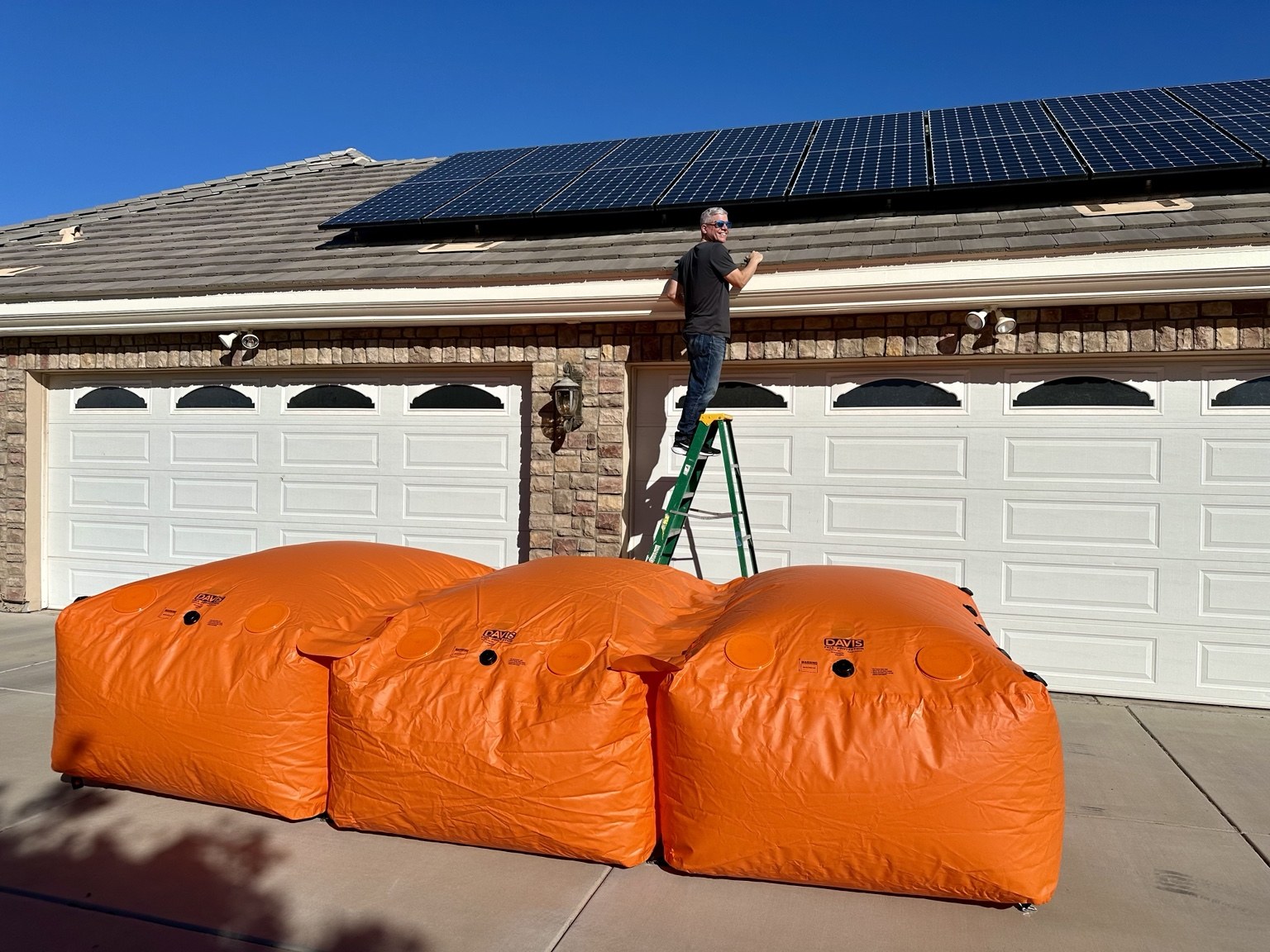 Davis fall protection bags beneath a ladder during roof maintenance